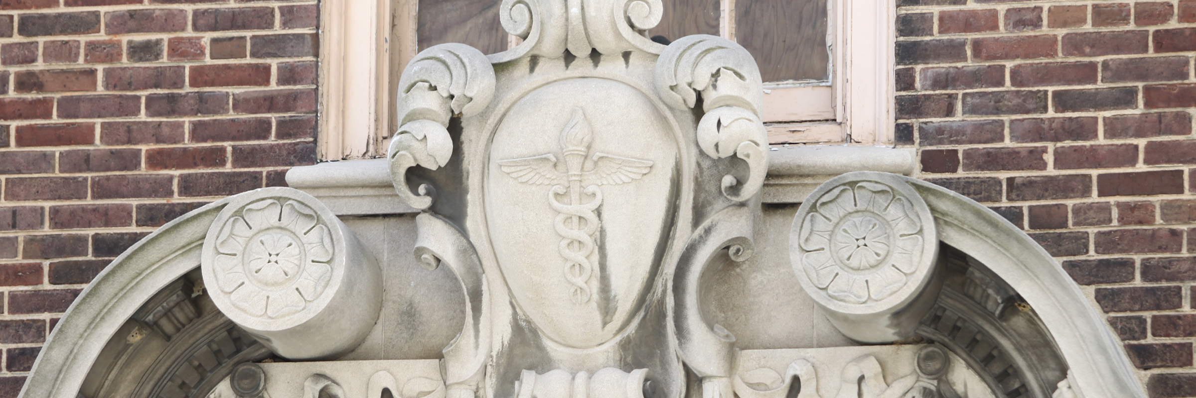 Closeup of the caduceus above the doorway of the Health Sciences Library on the MCV campus.