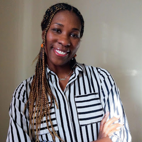 the image shows a black woman with long braids in a black and white horizontal striped top smiling against a neutral background