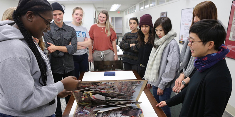 A group of students around a table with our Special Collections and Archives staff.