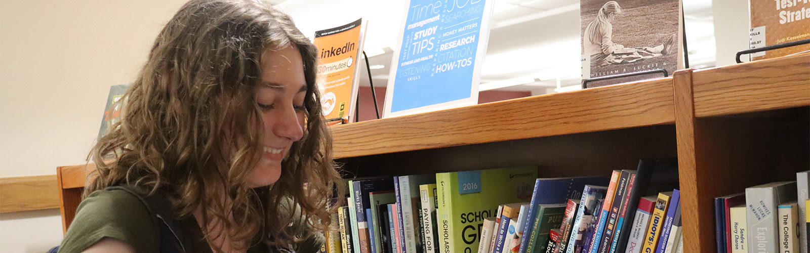 Josie Krasny browses books on the Student Success shelf at James Branch Cabell Library.