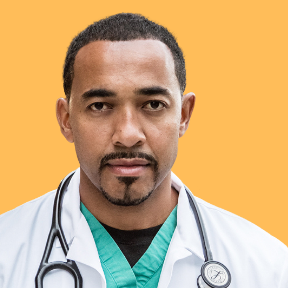 Portrait of Dr. Sampson Davis, wearing his doctor's white coat over scrubs and a stethoscope around his neck