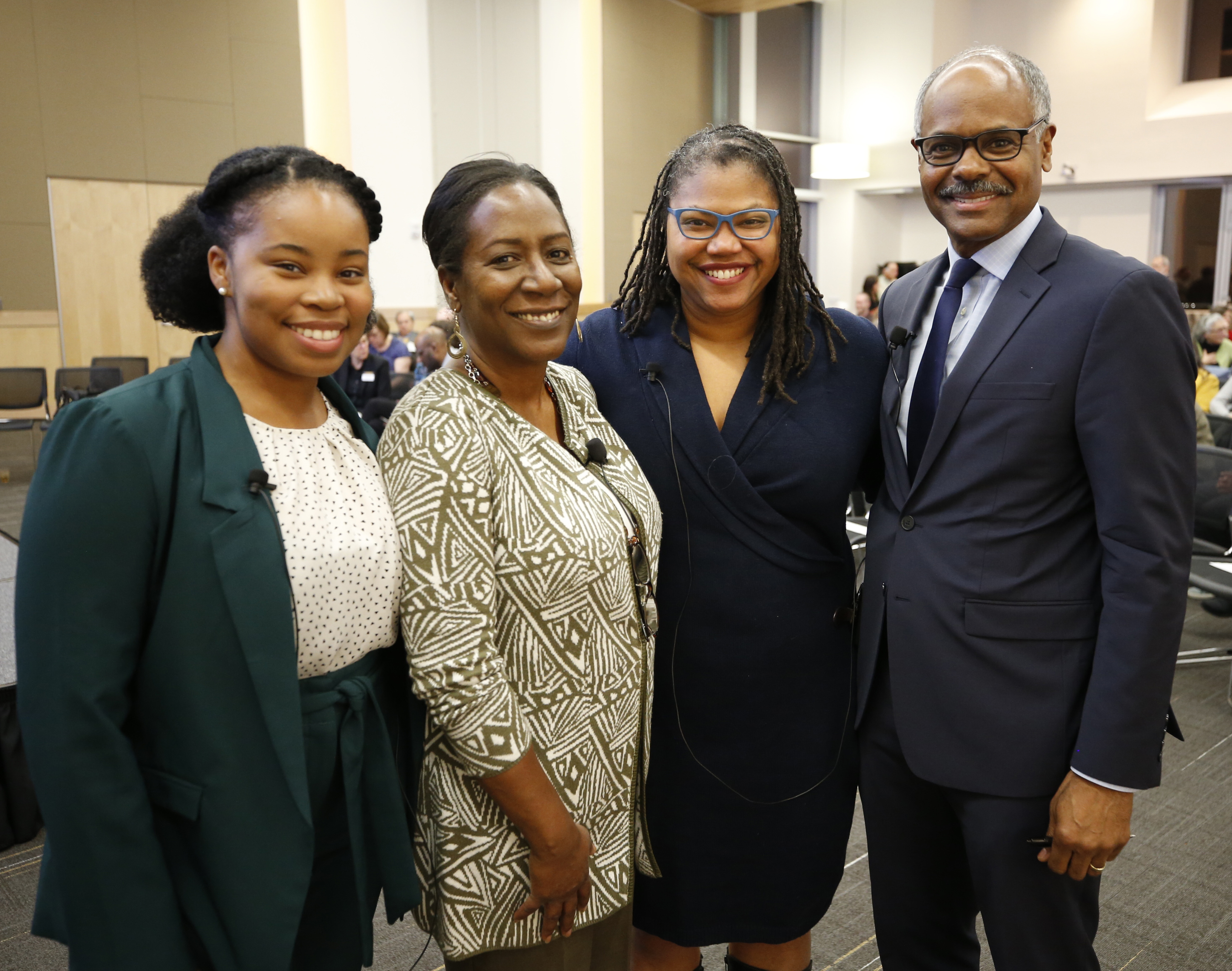 Kiara Boone, Christy Coleman, Adrian Lentz-Smith, and Jeffrey Blount posing for the camera in the Cabell Library Lecture Hall