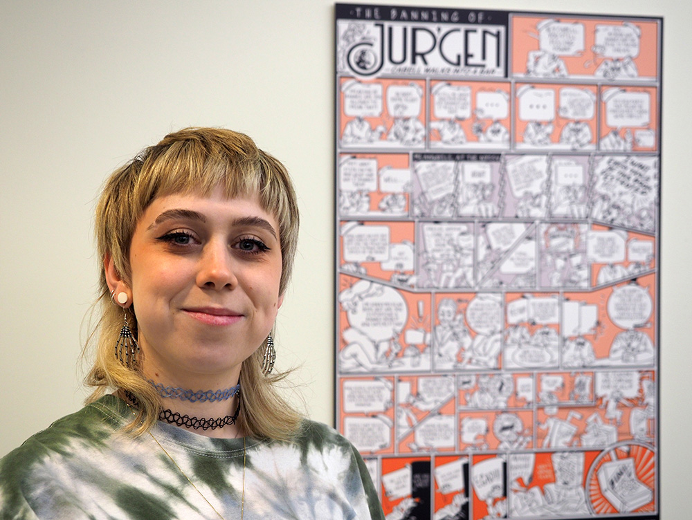 Erin Crawford standing in front of their winning entry for the Jurgen Comics Contest.