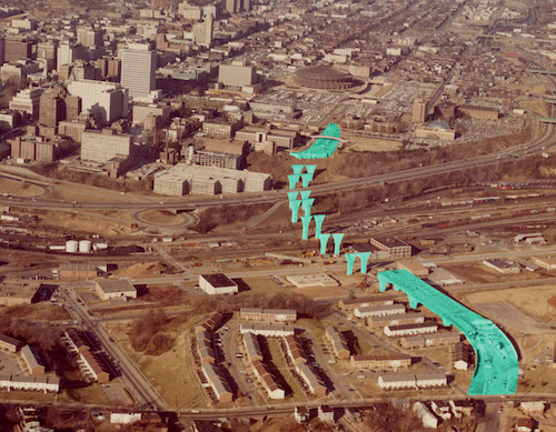 A '70s-era color aerial photograph of the construction of the Leigh St. Viaduct in Richmond, with the pylons and other construction elements highlighted in teal.